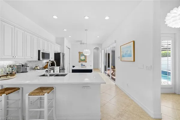 a kitchen with appliances a sink and cabinets
