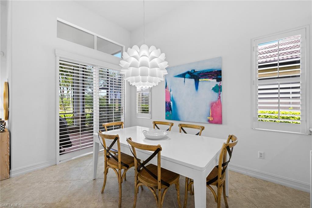 7785 Ashton Road Naples, FL 34113 - Photo 14 of 39 a view of a dining room with furniture and chandelier