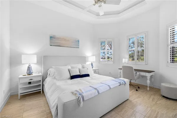 a bedroom with a bed and a table chair