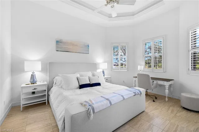 a bedroom with a bed and a table chair