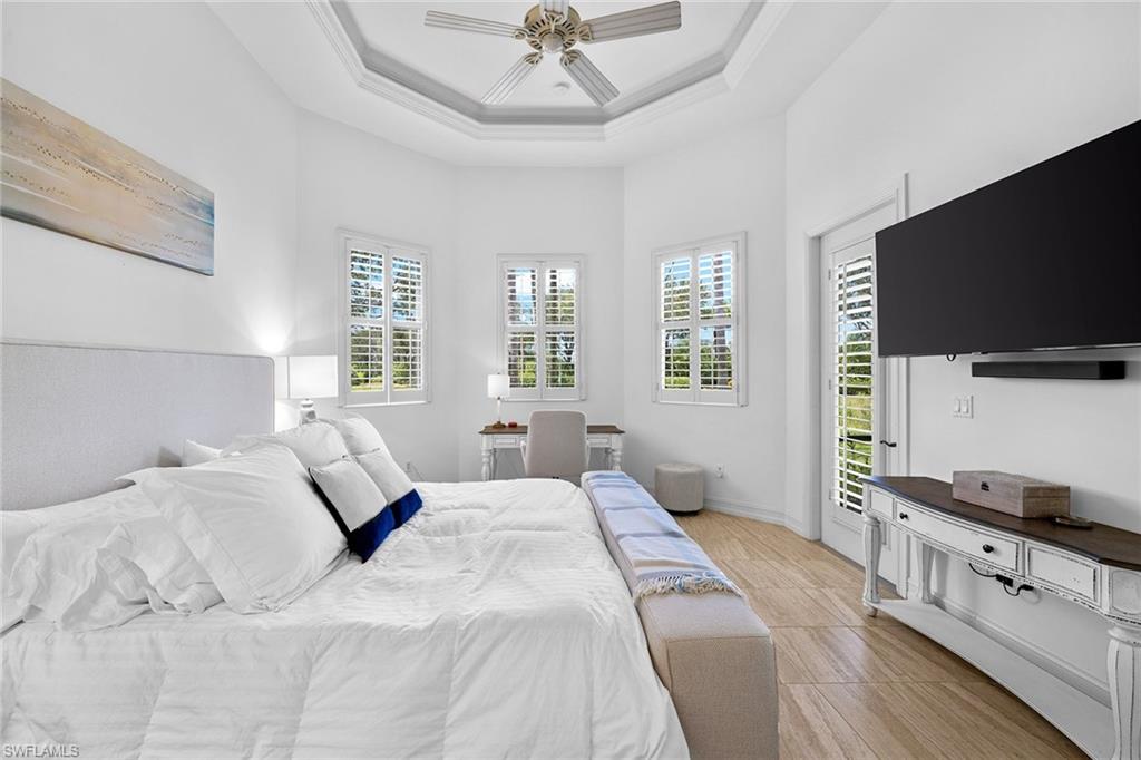 7785 Ashton Road Naples, FL 34113 - Photo 16 of 39 a bedroom with a bed and a flat screen tv