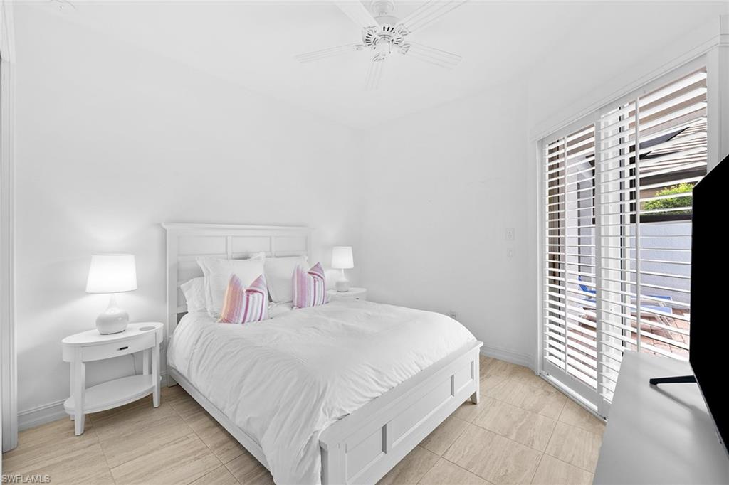 7785 Ashton Road Naples, FL 34113 - Photo 21 of 39 a bedroom with a bed and a large window