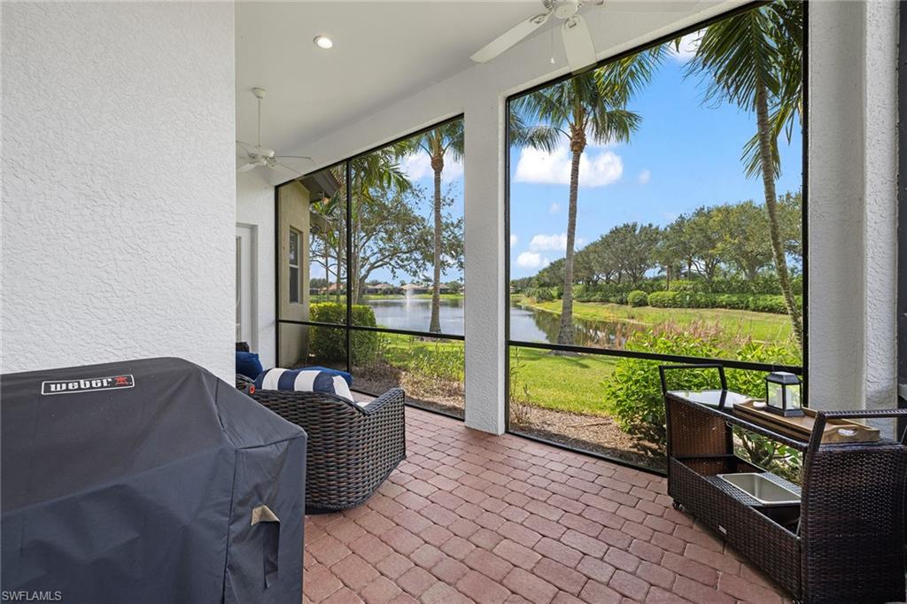 7785 Ashton Road Naples, FL 34113 - Photo 25 of 39 a living room with couch and a floor to ceiling window
