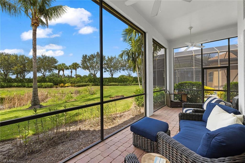 7785 Ashton Road Naples, FL 34113 - Photo 27 of 39 a view of a chair and tables in the balcony