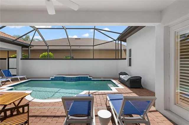 a room with pool table and chairs