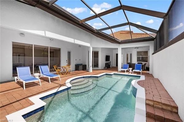 a view of swimming pool with seating area