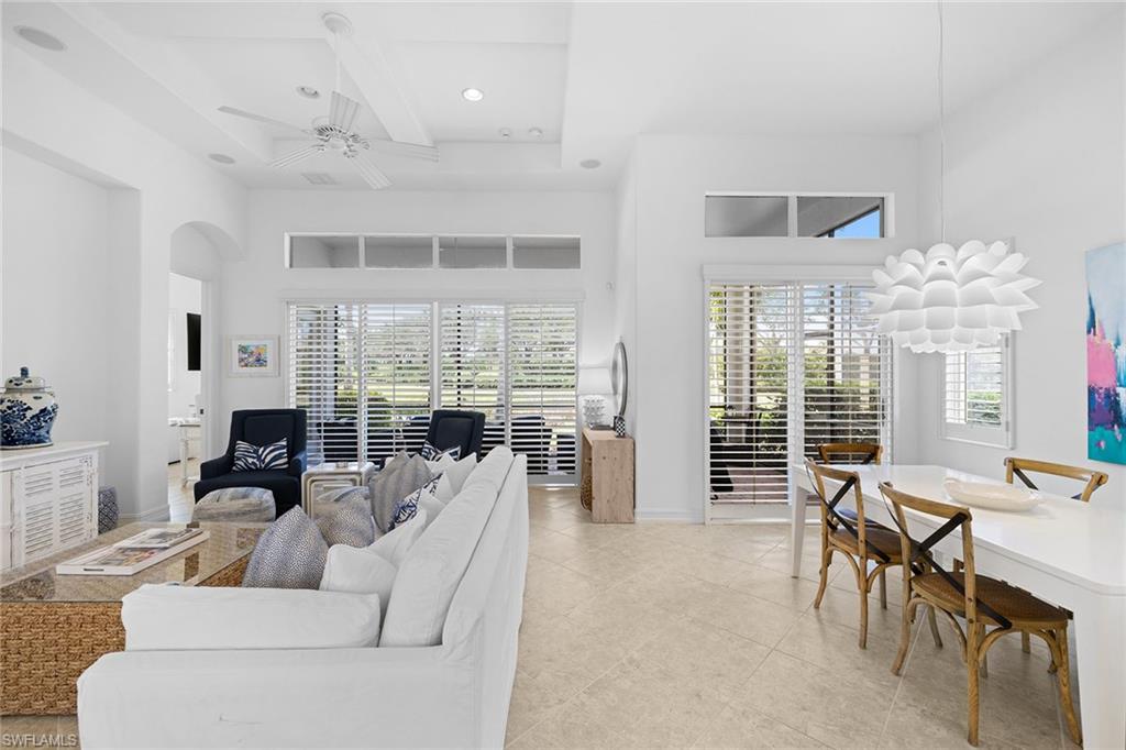 7785 Ashton Road Naples, FL 34113 - Photo 3 of 39 a living room with furniture and a large window