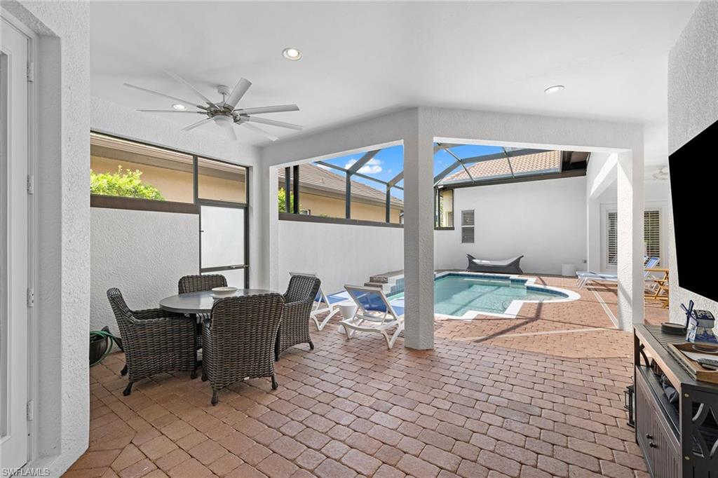 7785 Ashton Road Naples, FL 34113 - Photo 32 of 39 a living room with furniture and a flat screen tv