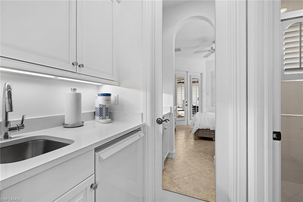 7785 Ashton Road Naples, FL 34113 - Photo 34 of 39 a kitchen with a sink and cabinets