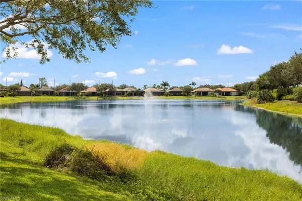a view of a lake with houses in the background