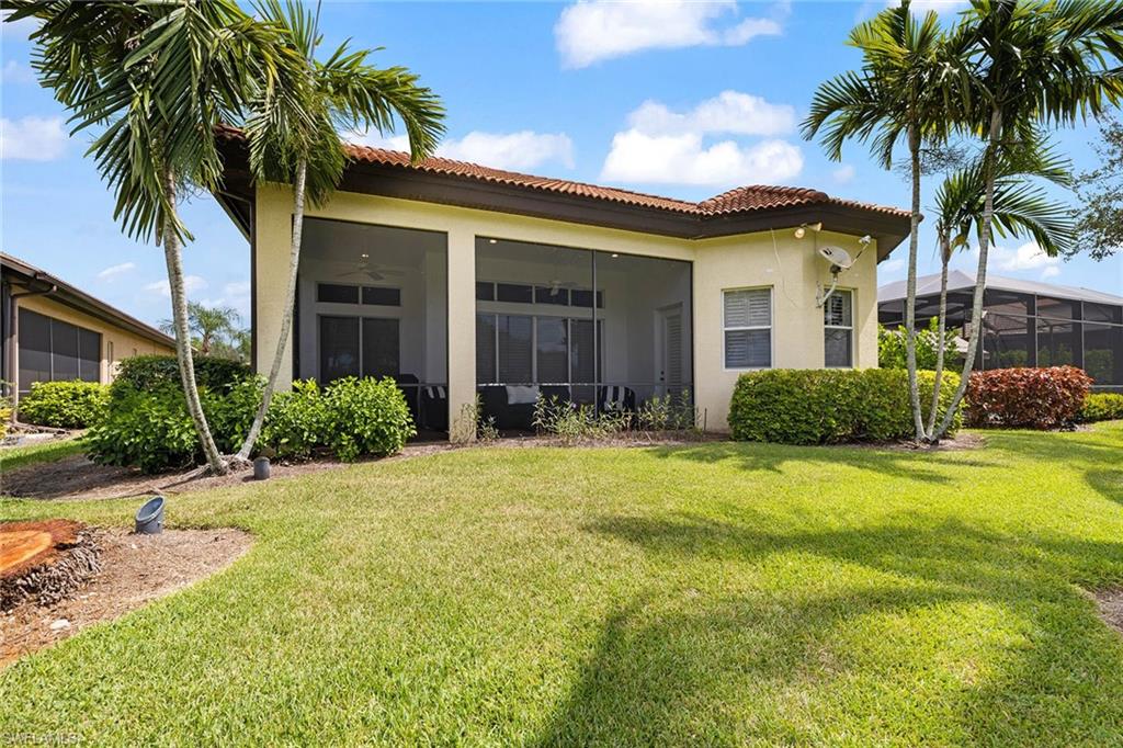 7785 Ashton Road Naples, FL 34113 - Photo 37 of 39 a front view of house and yard with green space