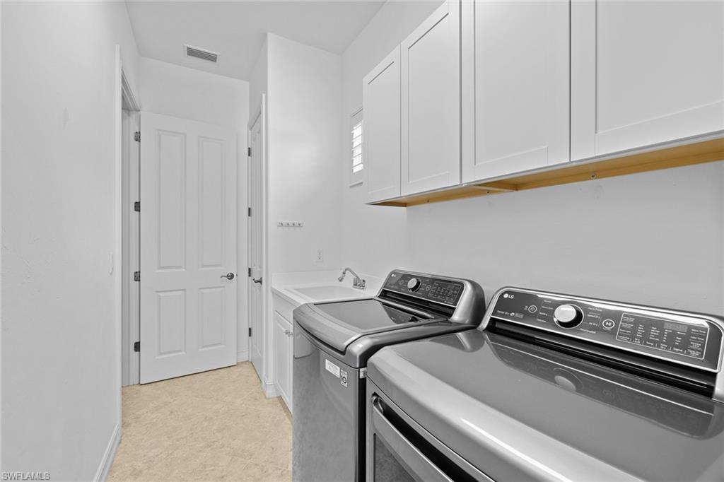 7785 Ashton Road Naples, FL 34113 - Photo 38 of 39 a room with storage and utility