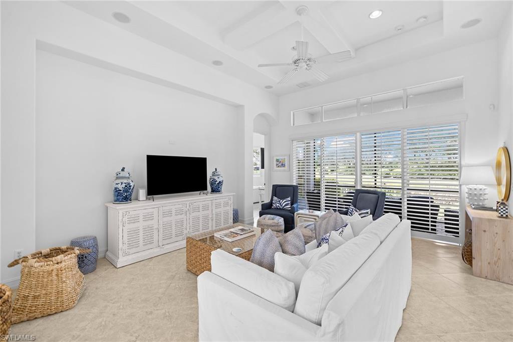 7785 Ashton Road Naples, FL 34113 - Photo 4 of 39 a living room with furniture and a flat screen tv