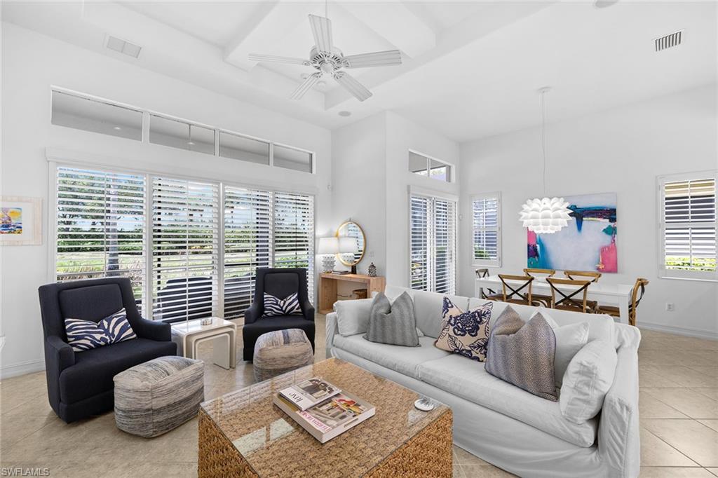 7785 Ashton Road Naples, FL 34113 - Photo 5 of 39 a living room with furniture and a large window