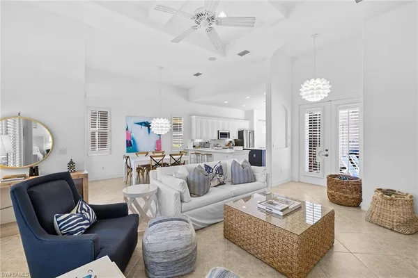 a living room with furniture a rug and a chandelier