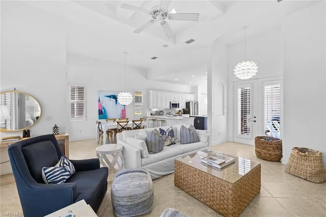 a living room with furniture a rug and a chandelier