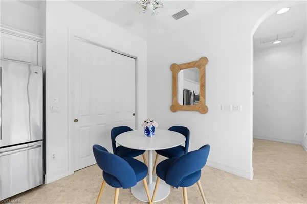 a dining room with furniture and a mirror