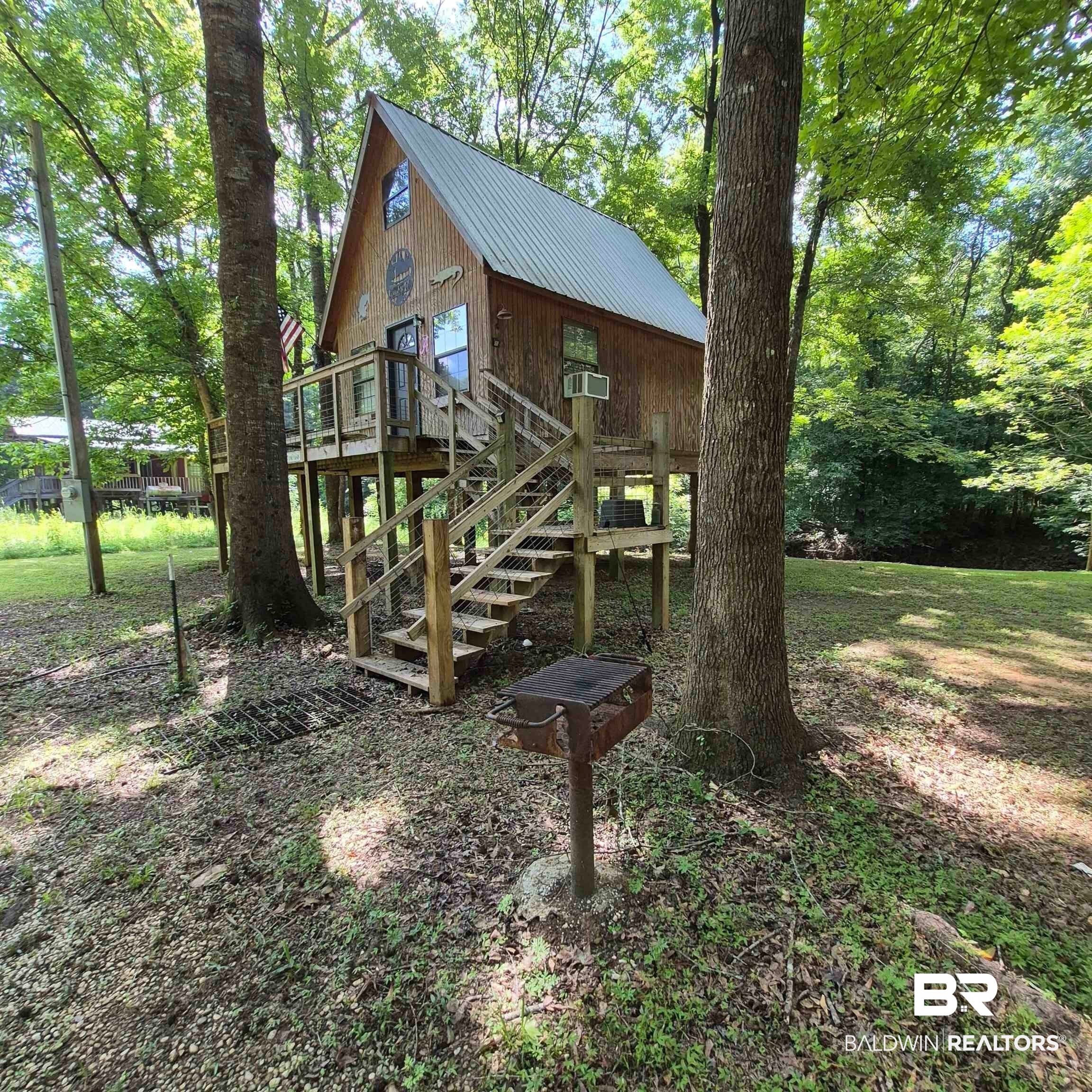 0 Eureka Landing Road Uriah, AL 36480 - Photo 4 of 27 Wood-sided structure with a metal roof and an elevated deck