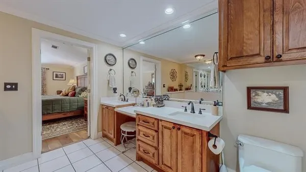a spacious bathroom with a tub sink and mirror