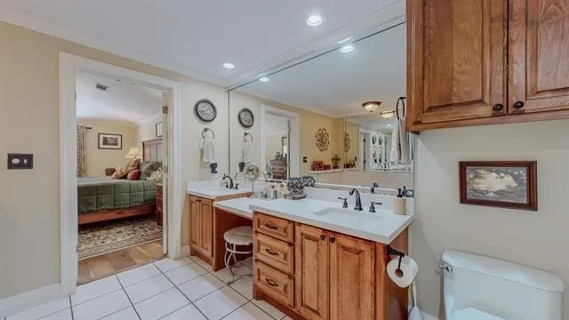 a spacious bathroom with a tub sink and mirror
