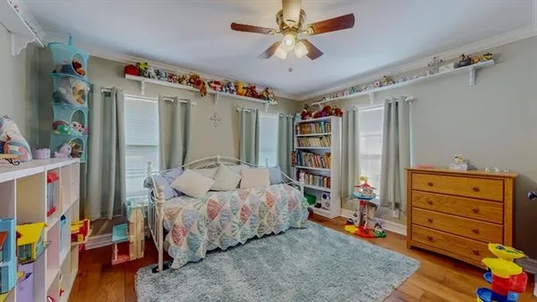 a living room with furniture and a book shelf