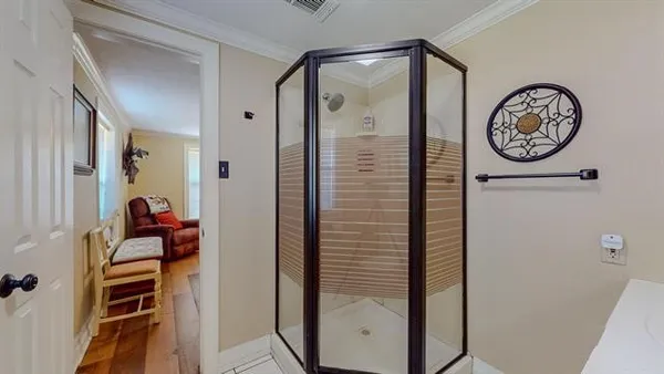 a bedroom with furniture entryway and wooden floor