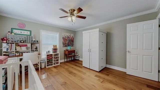 a bed sitting in a bedroom next to a lamp