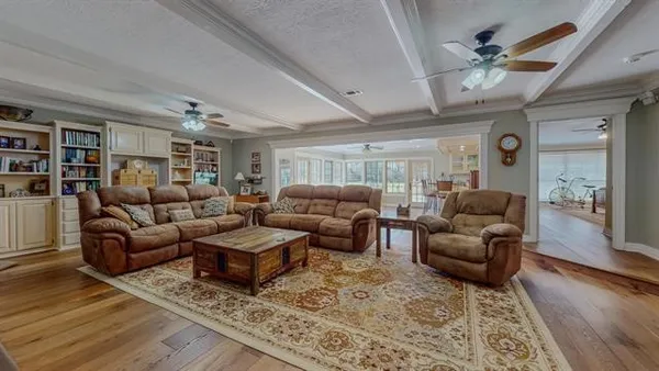 a living room with furniture and wooden floor