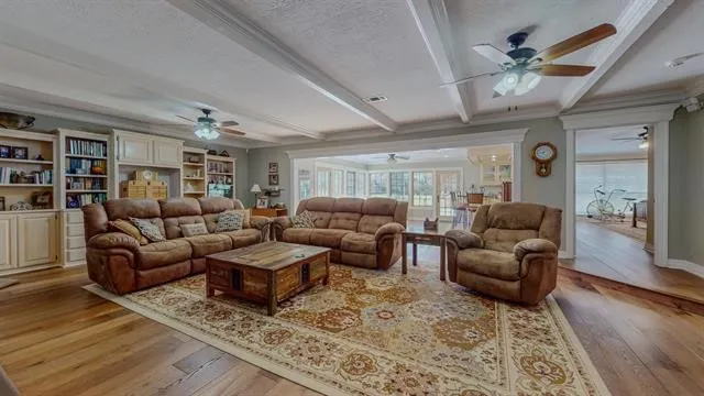 a living room with furniture and wooden floor