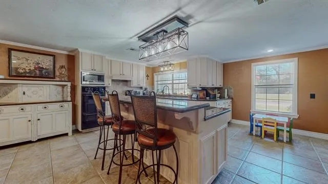 a kitchen with a cabinets and chairs