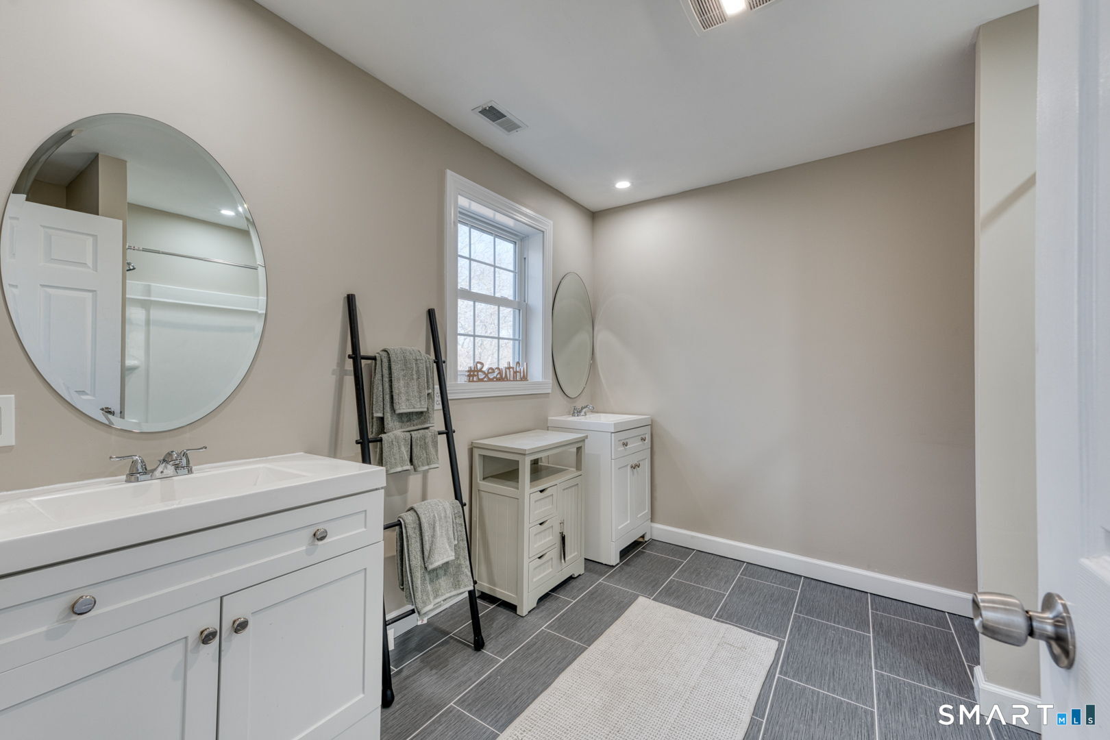 205 Winding Hollow Road Groton, CT 06340 - Photo 16 of 27 a bathroom with a sink mirror and vanity