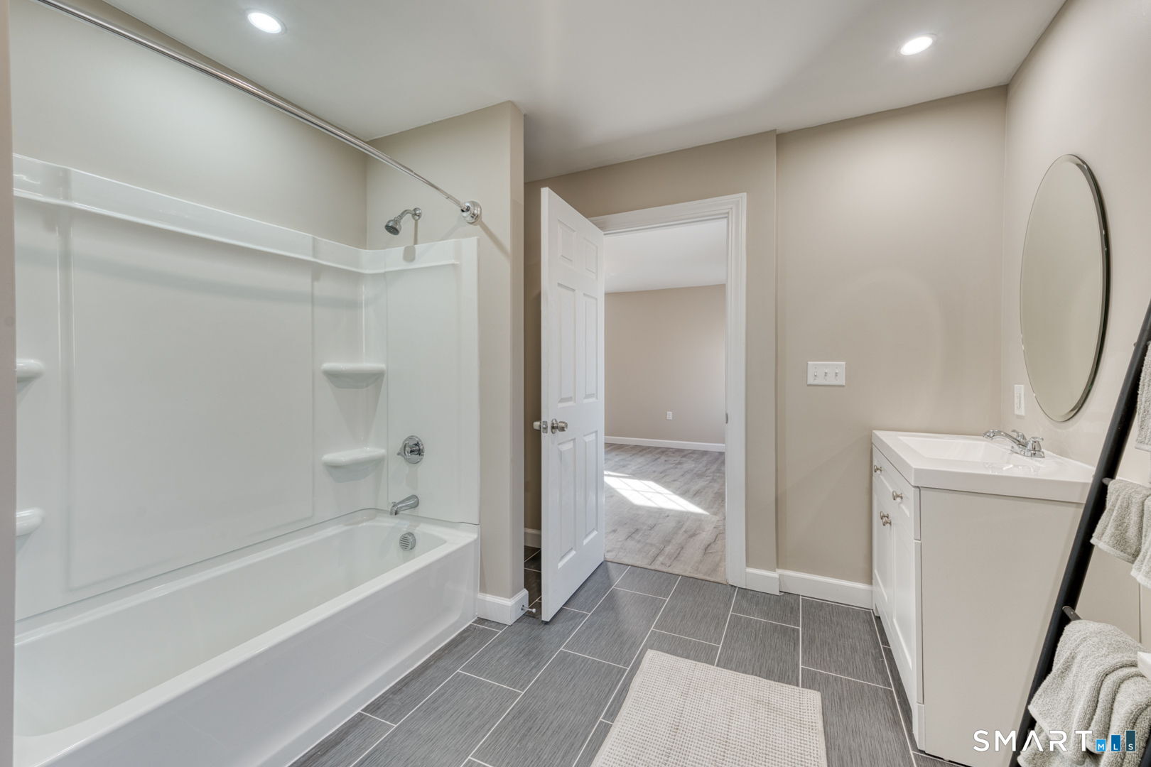 205 Winding Hollow Road Groton, CT 06340 - Photo 17 of 27 a bathroom with a bathtub and a shower