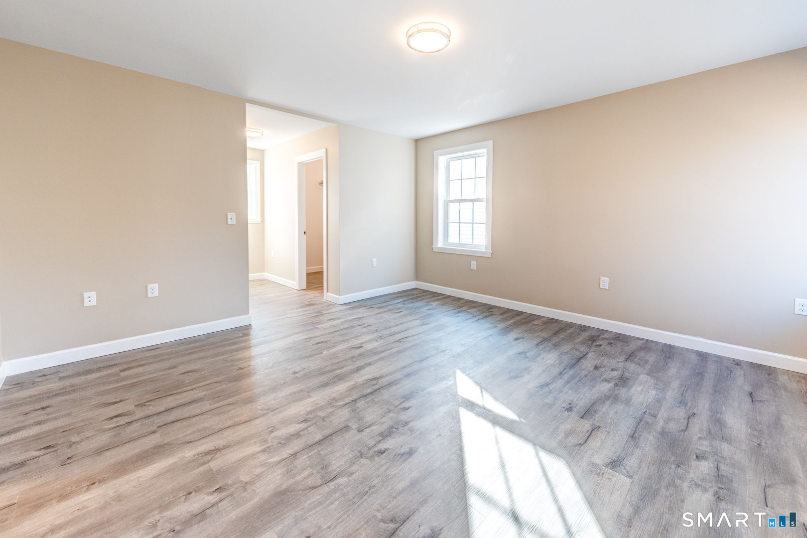 205 Winding Hollow Road Groton, CT 06340 - Photo 18 of 27 a view of an empty room with wooden floor and a window