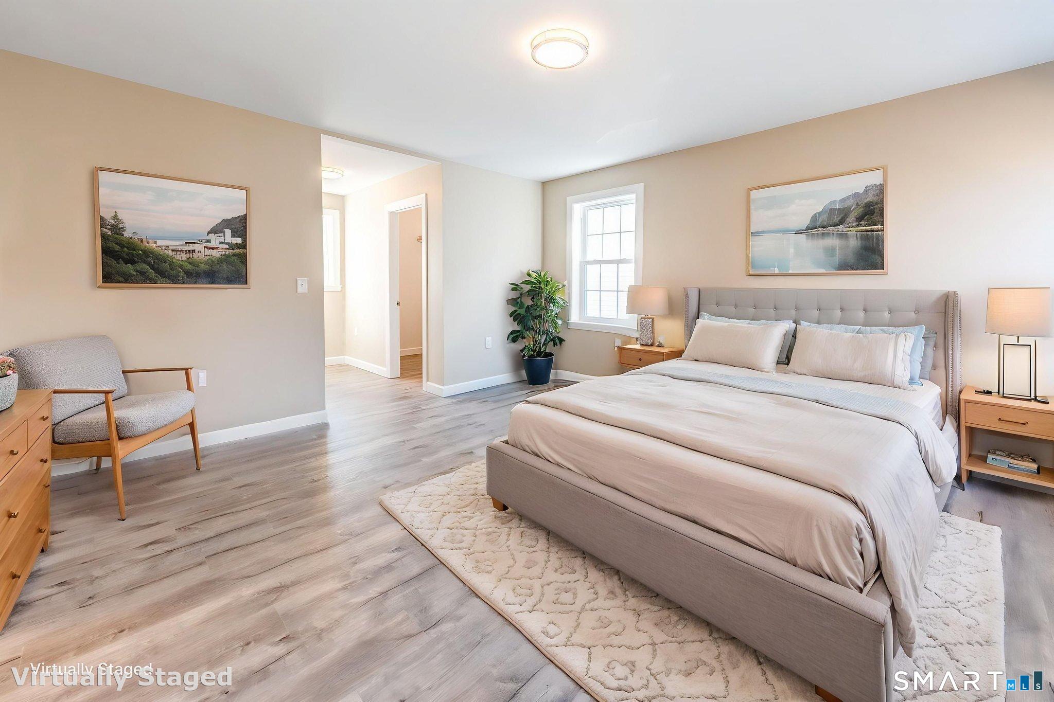205 Winding Hollow Road Groton, CT 06340 - Photo 19 of 27 a bedroom with a bed and a painting on the wall
