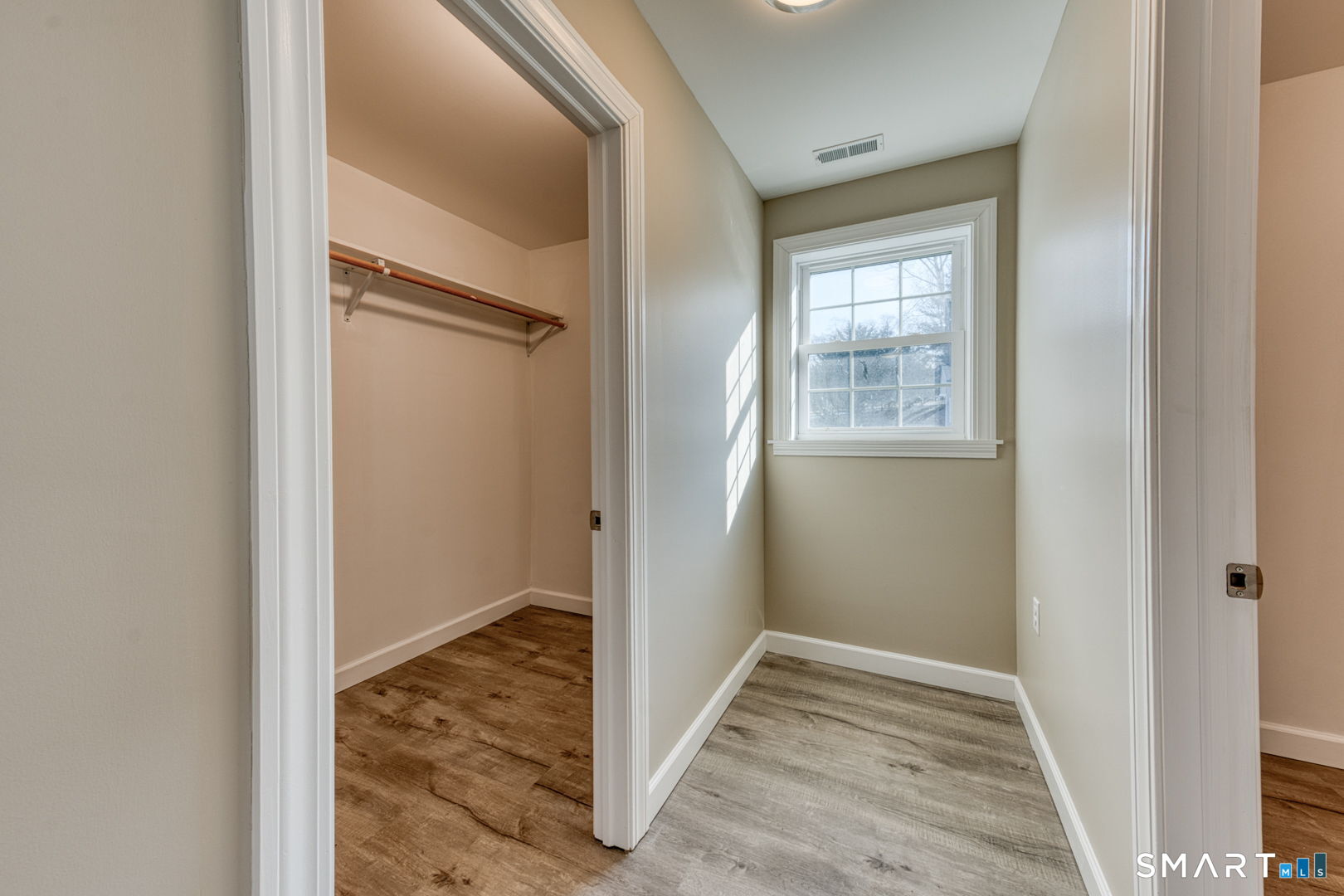 205 Winding Hollow Road Groton, CT 06340 - Photo 20 of 27 a view of hallway with window and wooden floor
