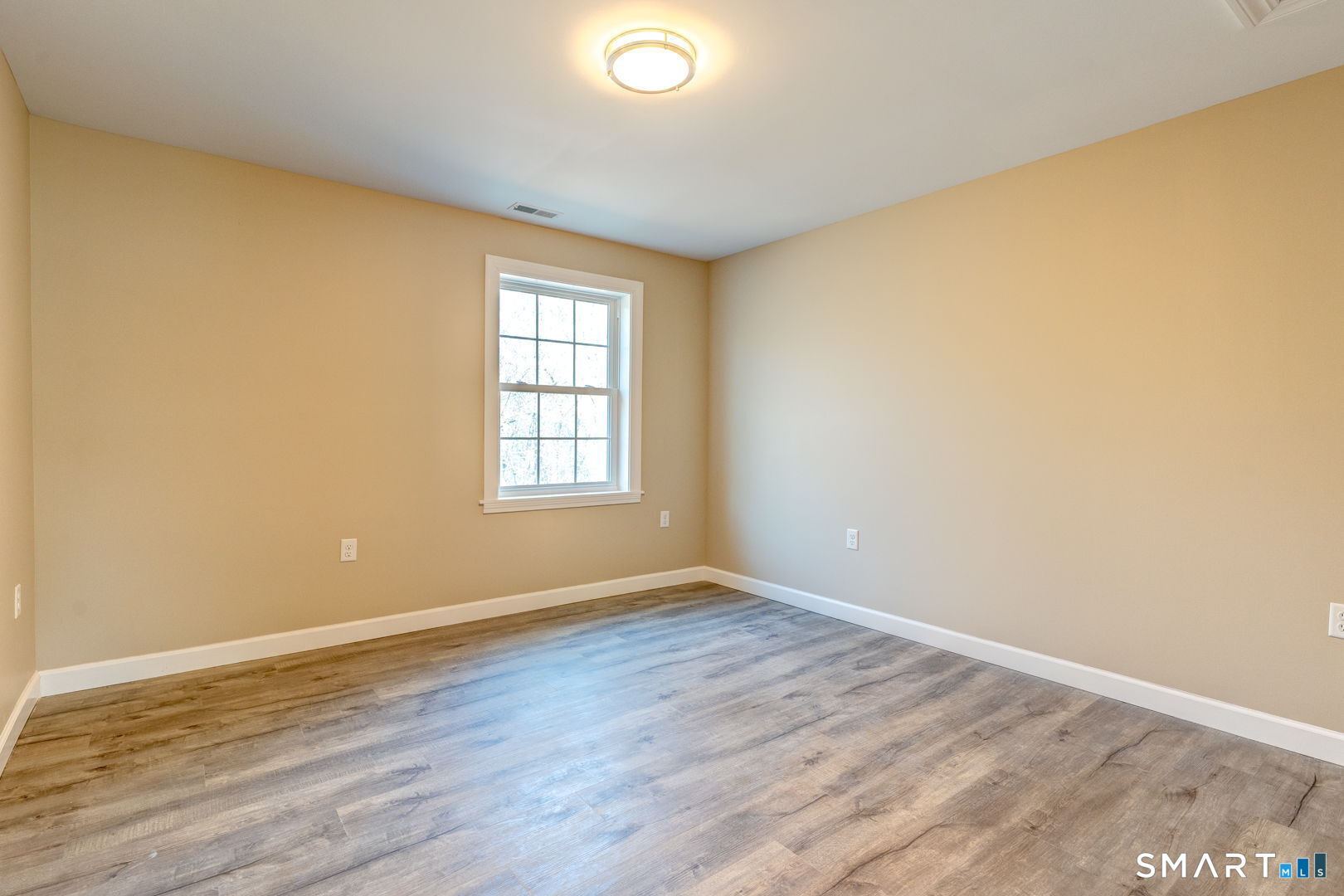 205 Winding Hollow Road Groton, CT 06340 - Photo 22 of 27 an empty room with wooden floor and windows