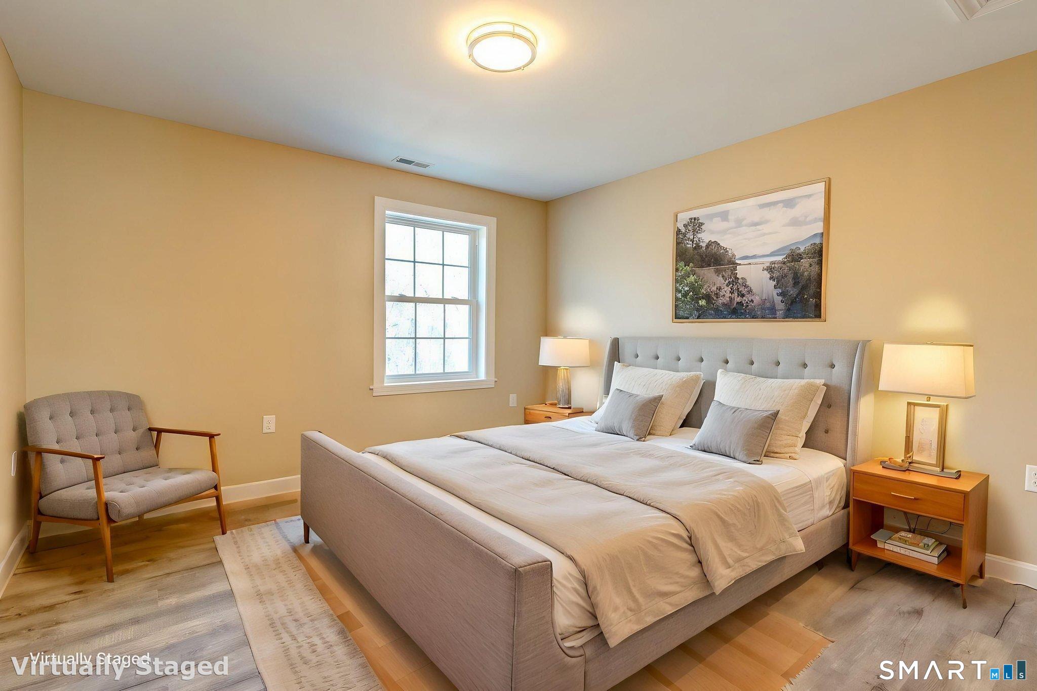 205 Winding Hollow Road Groton, CT 06340 - Photo 23 of 27 a bedroom with a bed and a chair