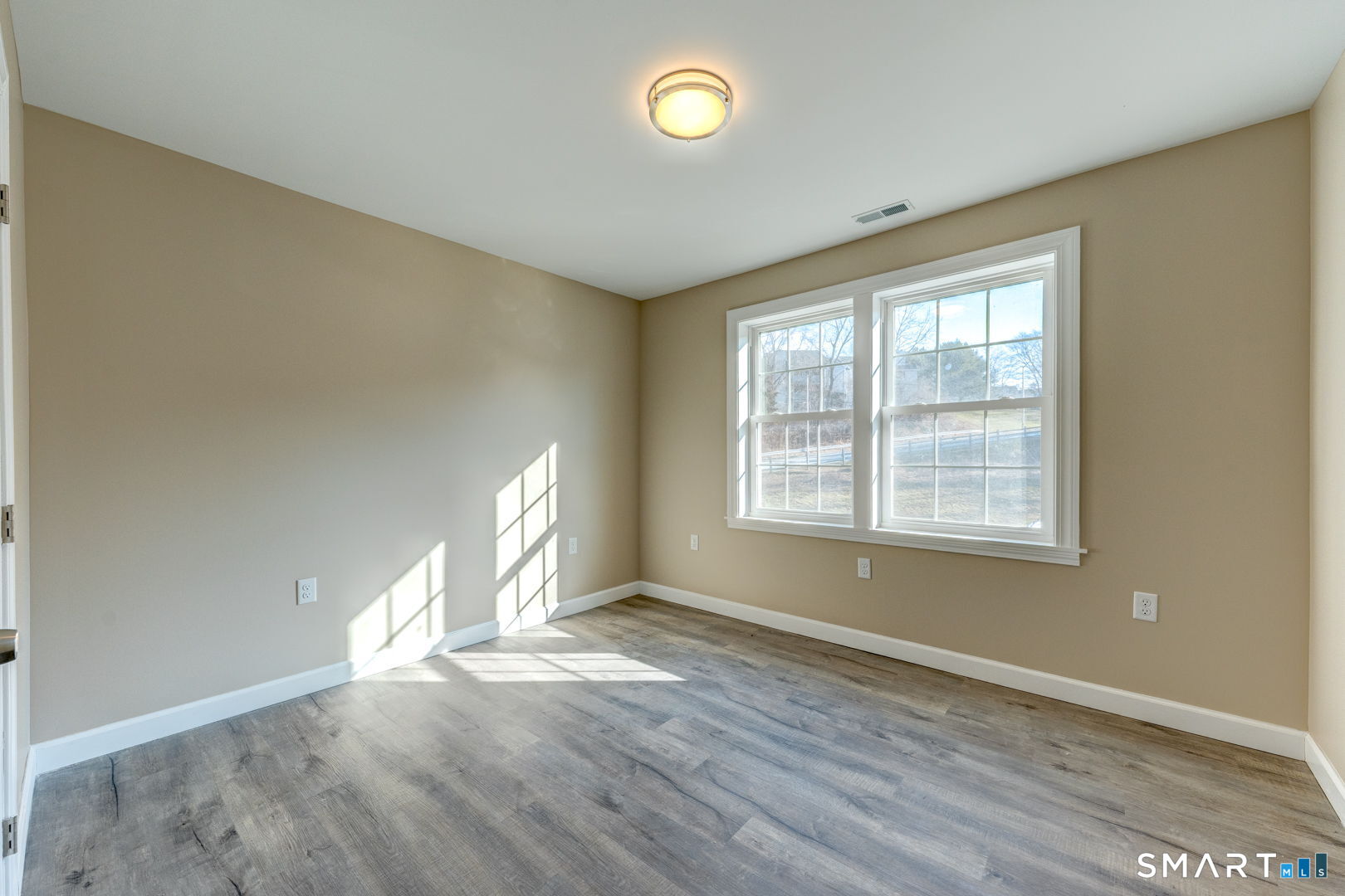 205 Winding Hollow Road Groton, CT 06340 - Photo 24 of 27 a view of empty room with wooden floor and fan