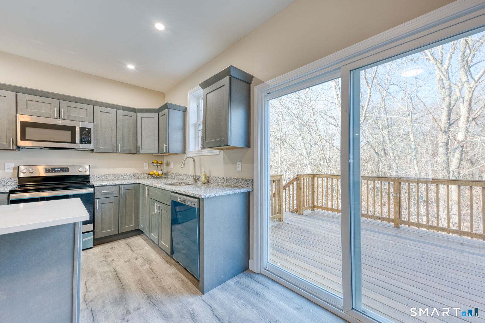 205 Winding Hollow Road Groton, CT 06340 - Photo 8 of 27 a kitchen with a stove a sink and a microwave