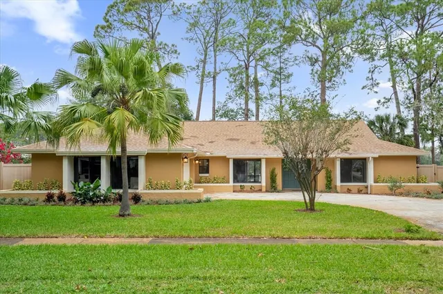 a front view of house with yard and green space