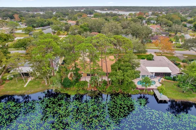 an aerial view of a house with a yard