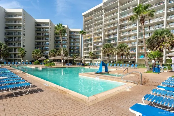 a view of a swimming pool with a lounge chairs