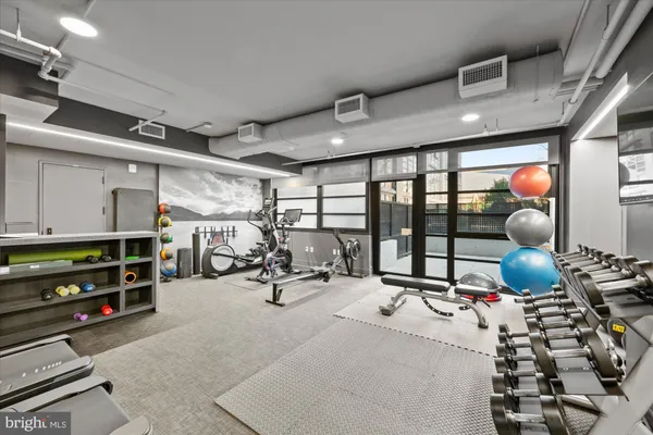 a room with gym equipment and a large window
