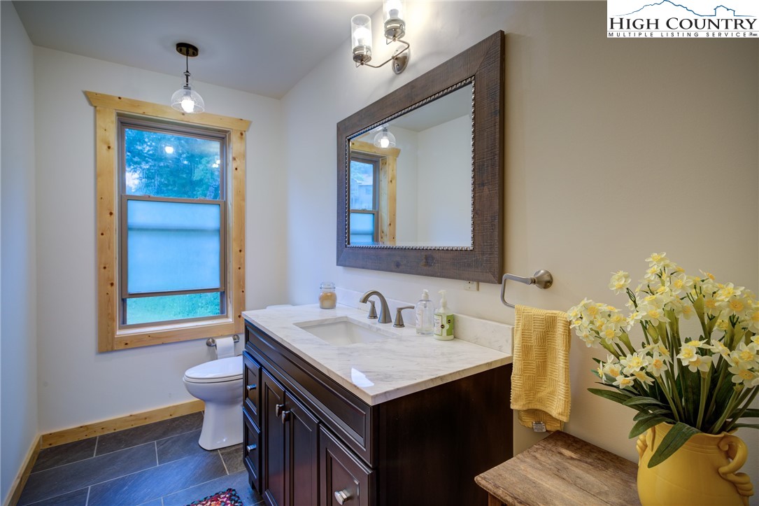 111 Boca Ridge Road Boone, NC 28607 - Photo 13 of 44 a bathroom with a sink a toilet and mirror