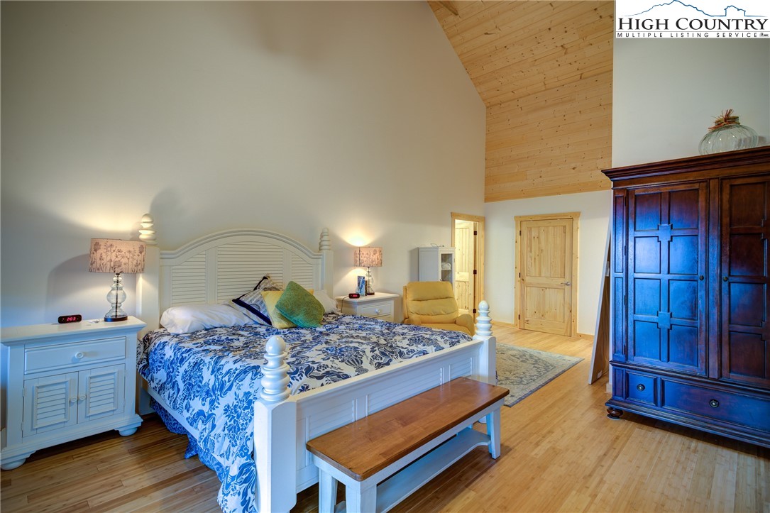 111 Boca Ridge Road Boone, NC 28607 - Photo 16 of 44 a bedroom with a bed and wooden floor