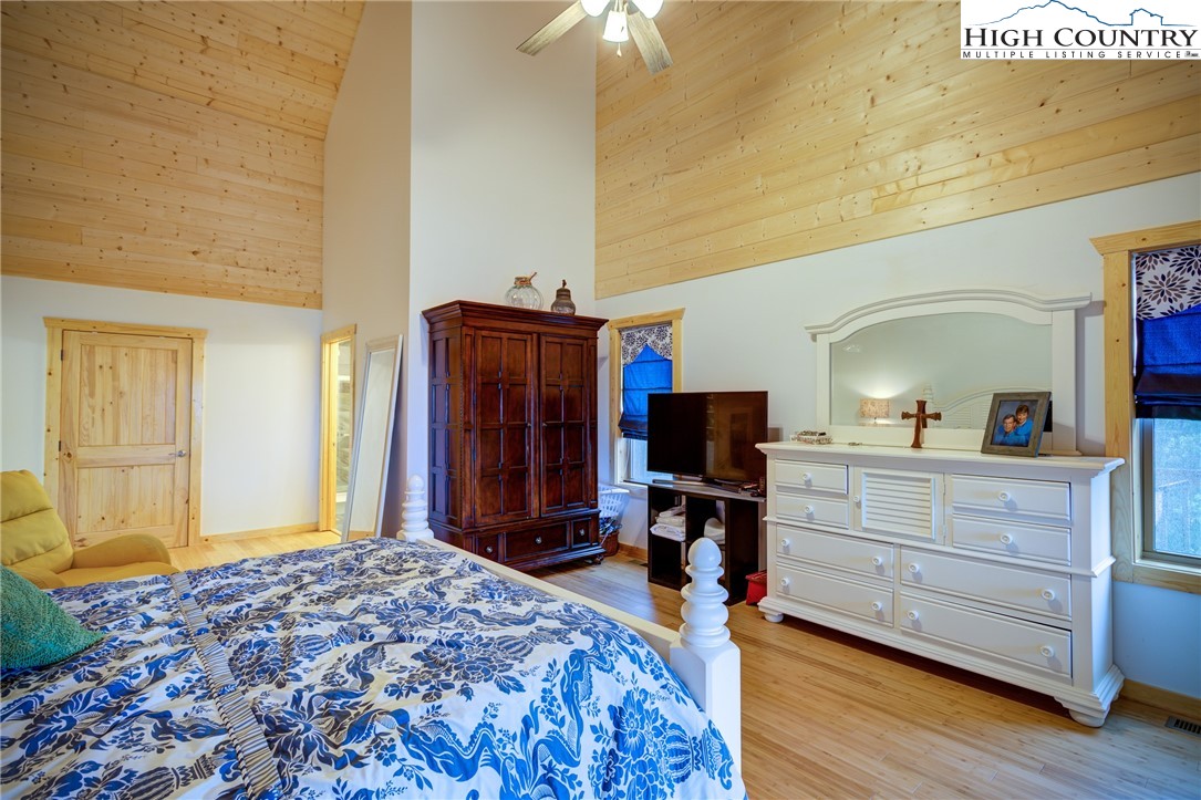 111 Boca Ridge Road Boone, NC 28607 - Photo 17 of 44 a bedroom with a bed and a flat tv screen on dresser