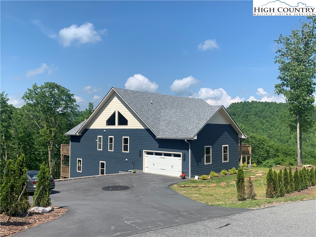 111 Boca Ridge Road Boone, NC 28607 - Photo 2 of 44 a front view of a house with a yard and garage