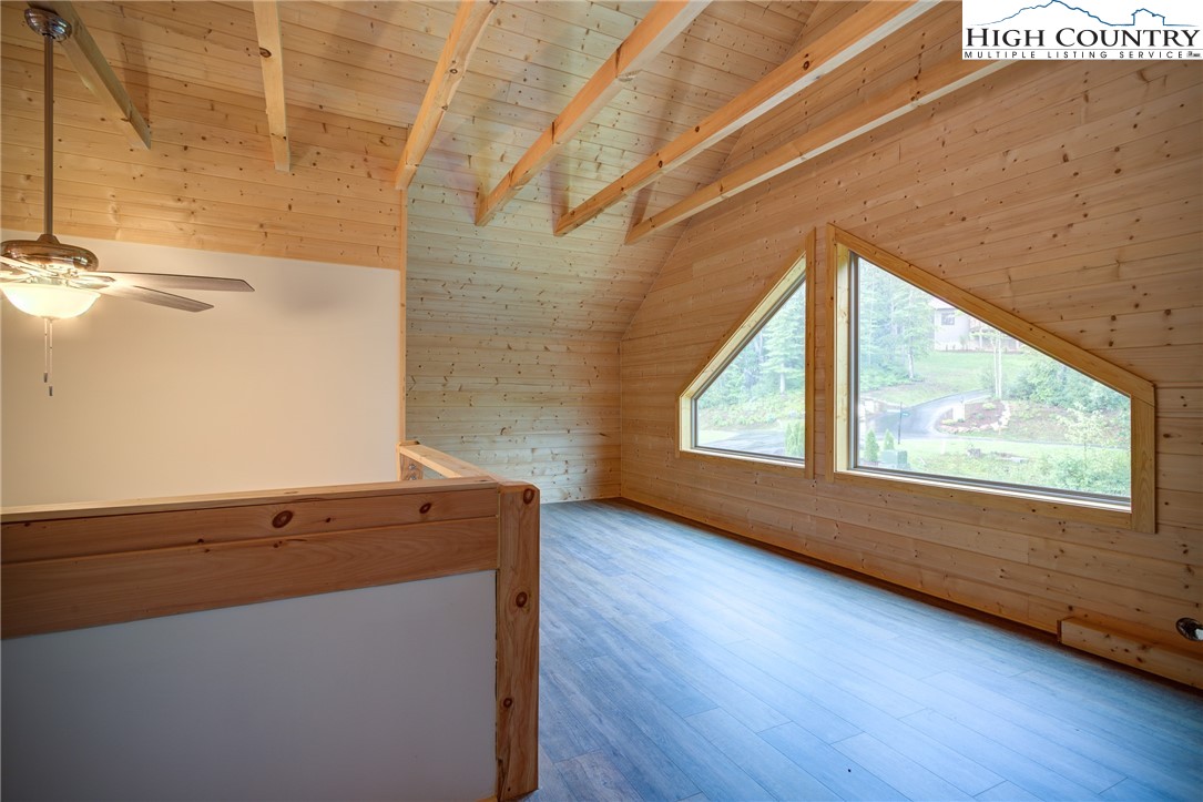111 Boca Ridge Road Boone, NC 28607 - Photo 21 of 44 a view of an empty room with wooden floor and a window