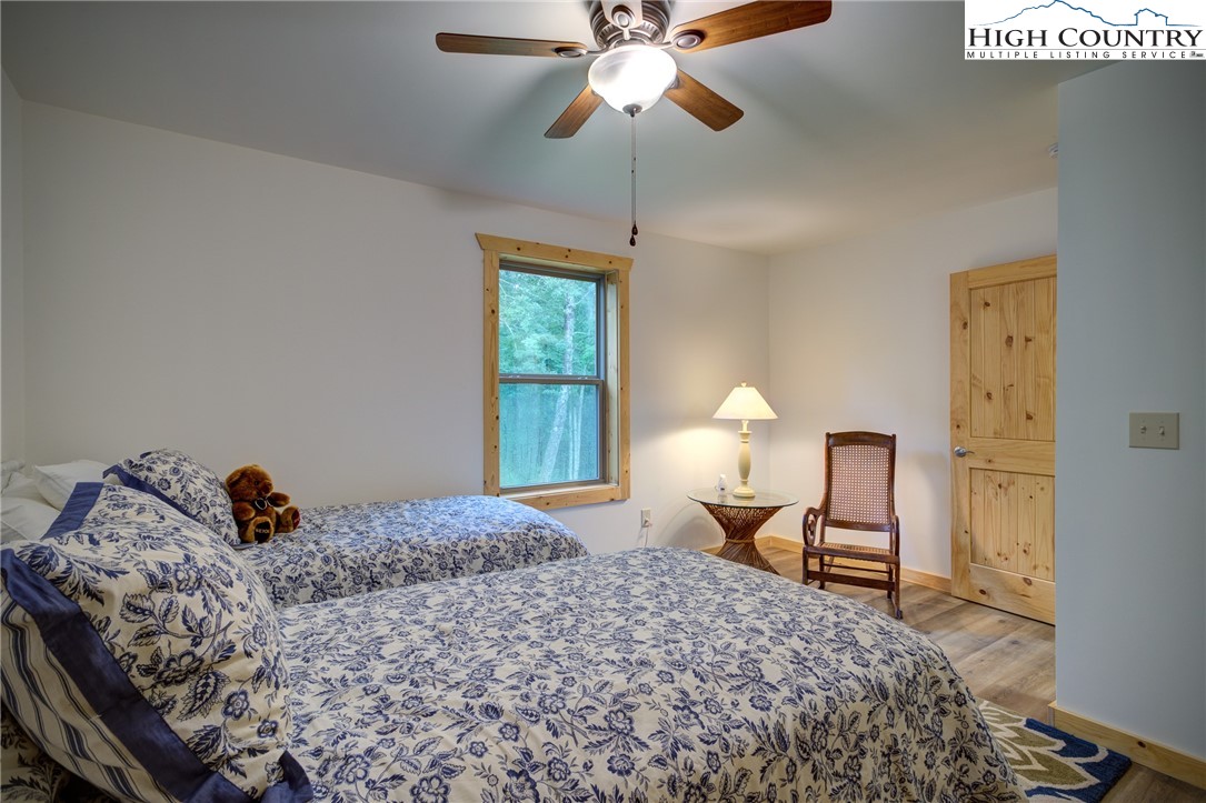 111 Boca Ridge Road Boone, NC 28607 - Photo 32 of 44 a bedroom with a bed and a chandelier