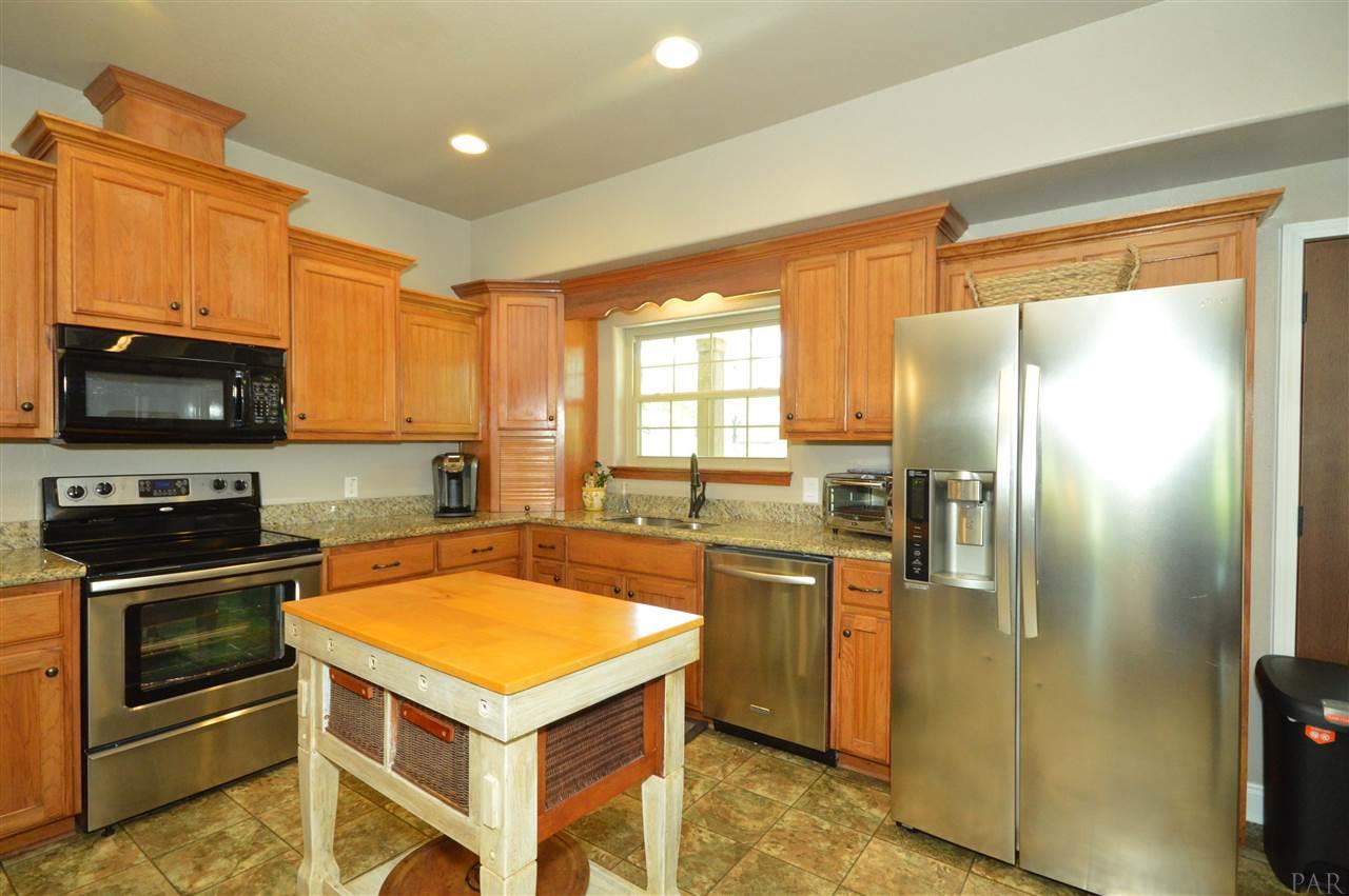 5611 Rolyat Road Pace, FL 32571 - Photo 15 of 46 Island and Refrigerator convey